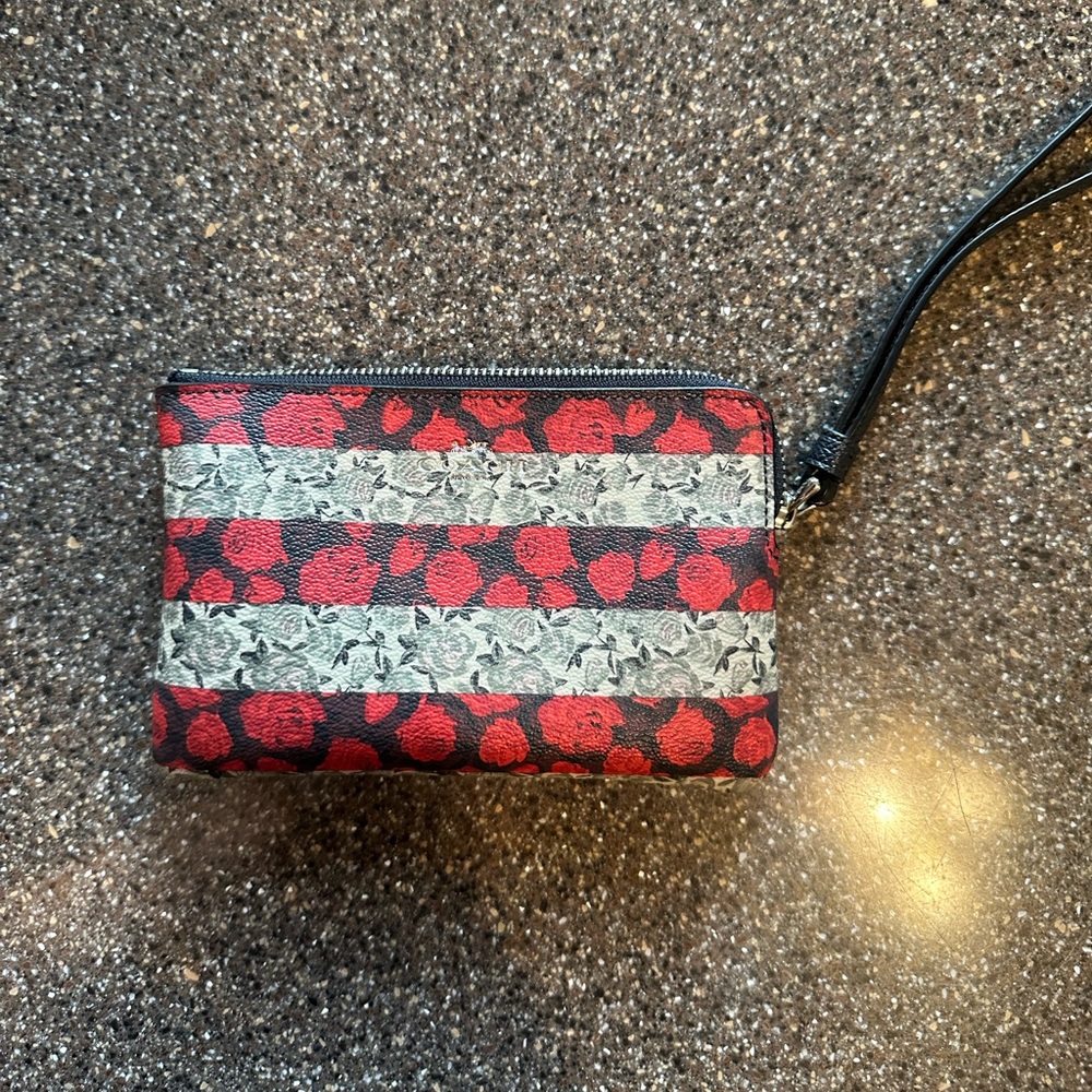 Coach Corner Zip Wristlet. Striped floral/rose design. Like new.